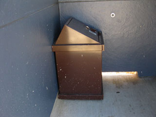 In the bathroom there is a trash can.