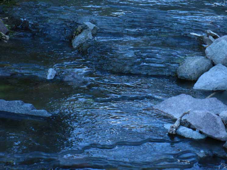 Water frozen into slush layers and stacked up on Wolf Creek.