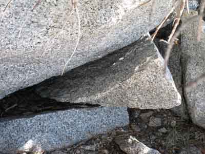 Granite block exfoliating into boulder.