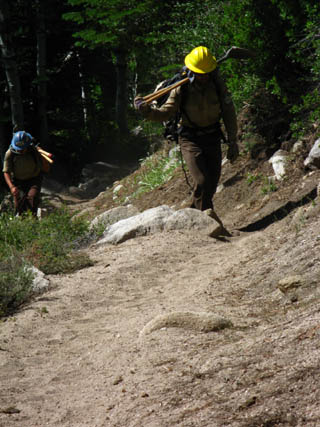 CCC Trail Workers moving up trail with tools.