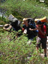Troop 13 members moving with packs