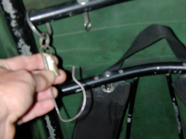 attachment clip for slung loads on an external framed backpack